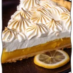 Sliced Lemon Meringue Tart on a plate.